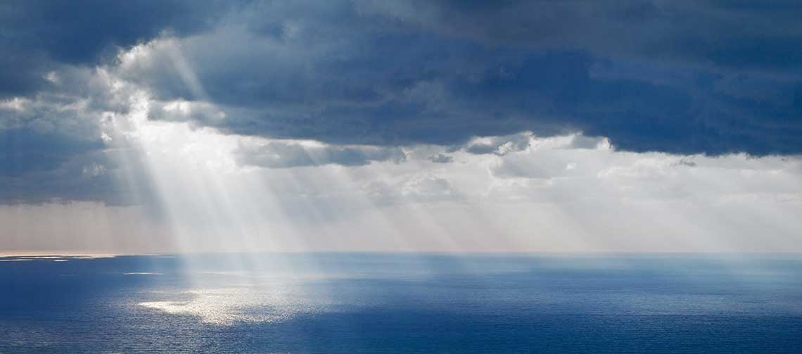 Seascape with rays of sunshine peeking through