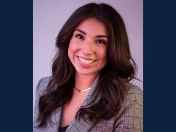 Woman with brown hair smiling.