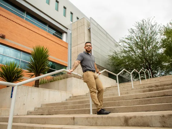 Student Standing on Stairs Outside of McClelland Hall