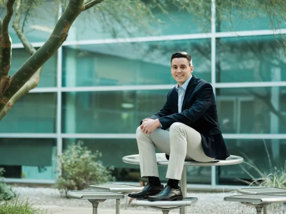 Eller student sitting in courtyard