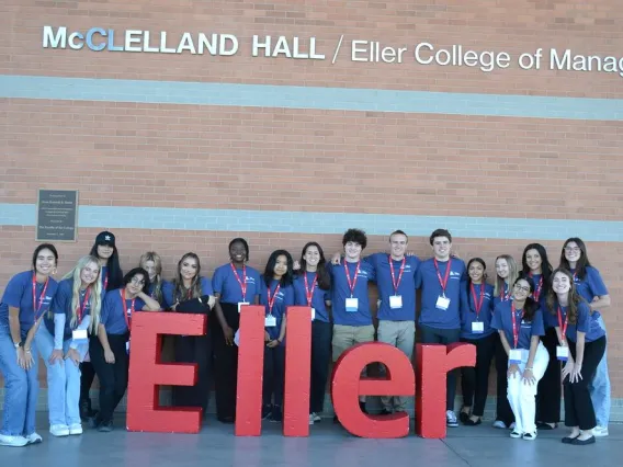 Group picture of student volunteers in front of building