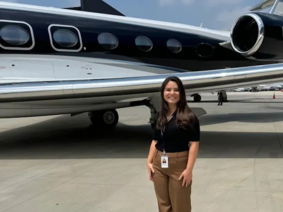 Girl standing in front of a plane