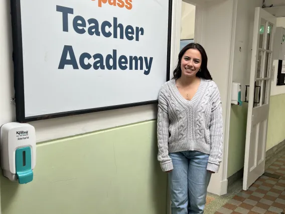 girl in front of logo