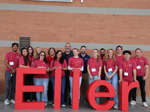 Group picture of student volunteers in front of building