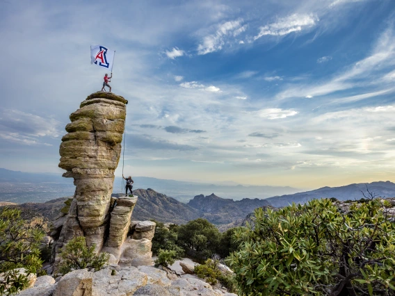 Meckler Photo - climbing windy point and placing Block A flag atop the point.