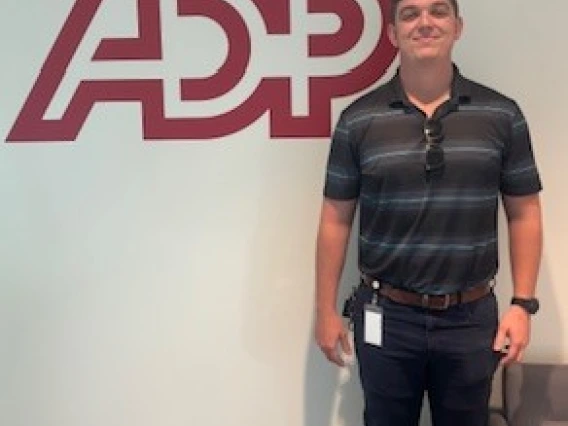 man standing in front of ADP logo