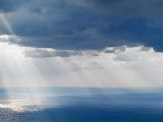 Seascape with rays of sunshine peeking through