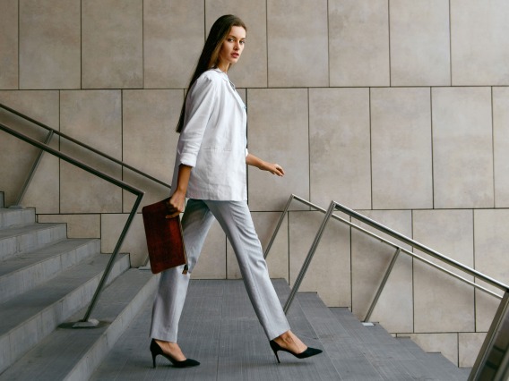 Business woman walking with a purse
