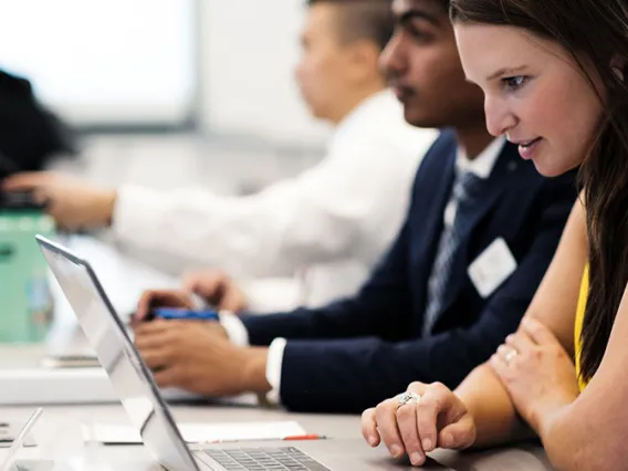 MBA students on laptop computers