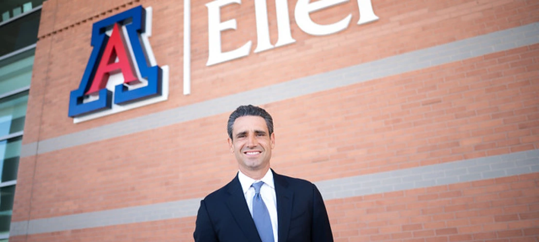 Ernie Garcia below the Eller logo sign outside of McClelland Hall