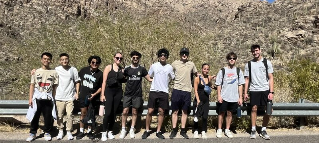 Students on a hike in front of the mountains