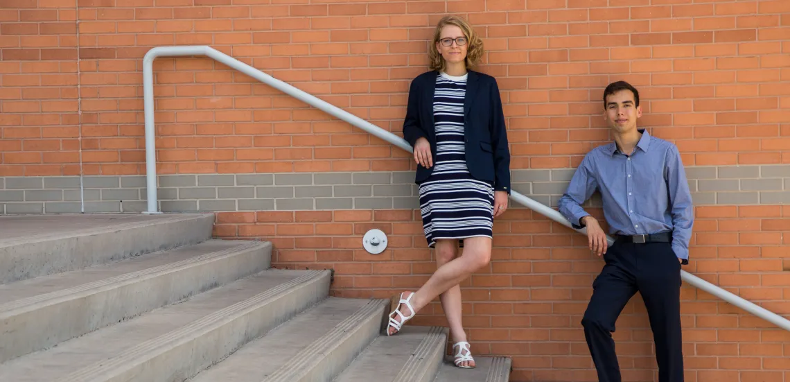 Two students standing on steps outside Eller