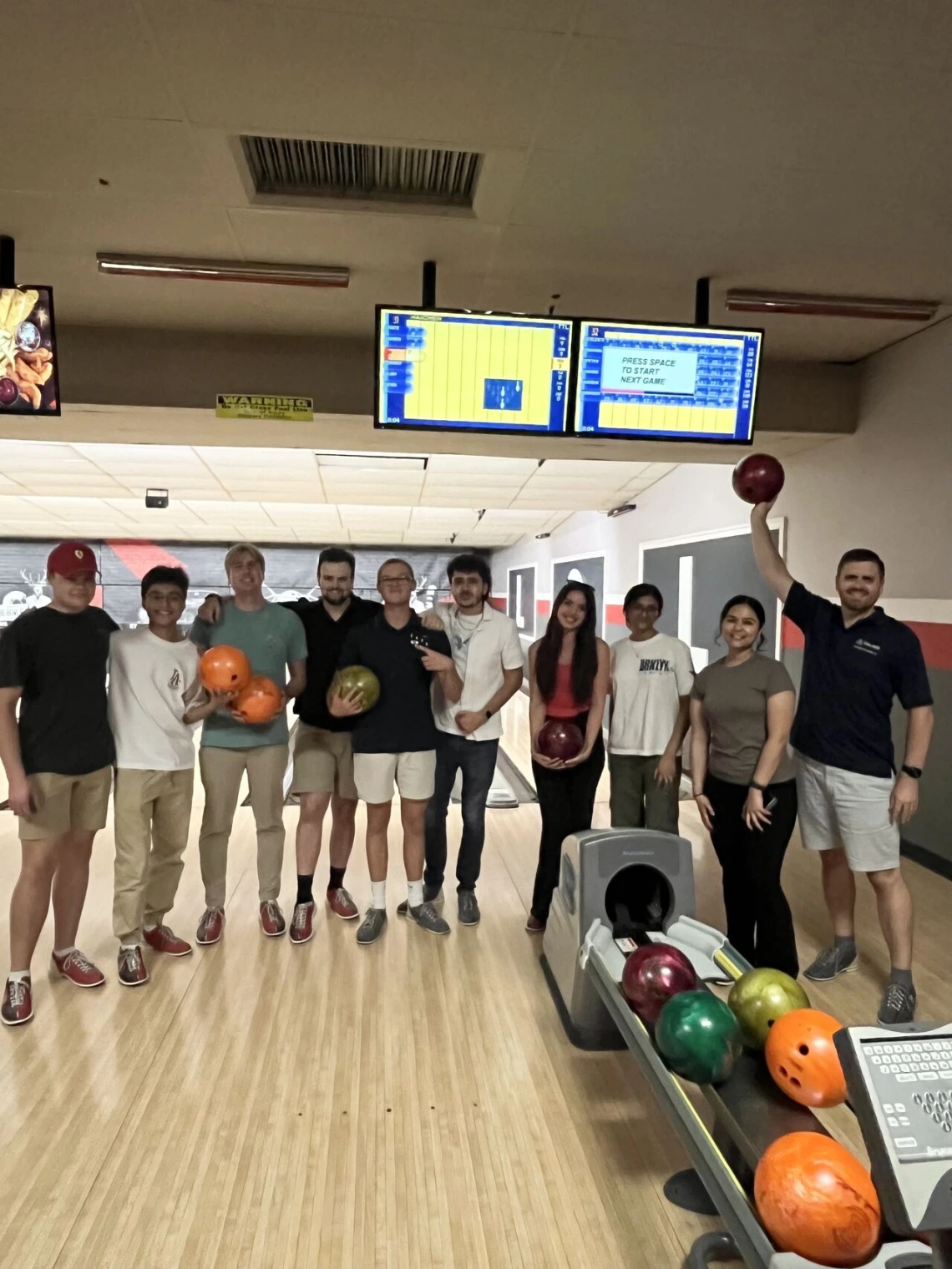 Students standing on a bowling alley