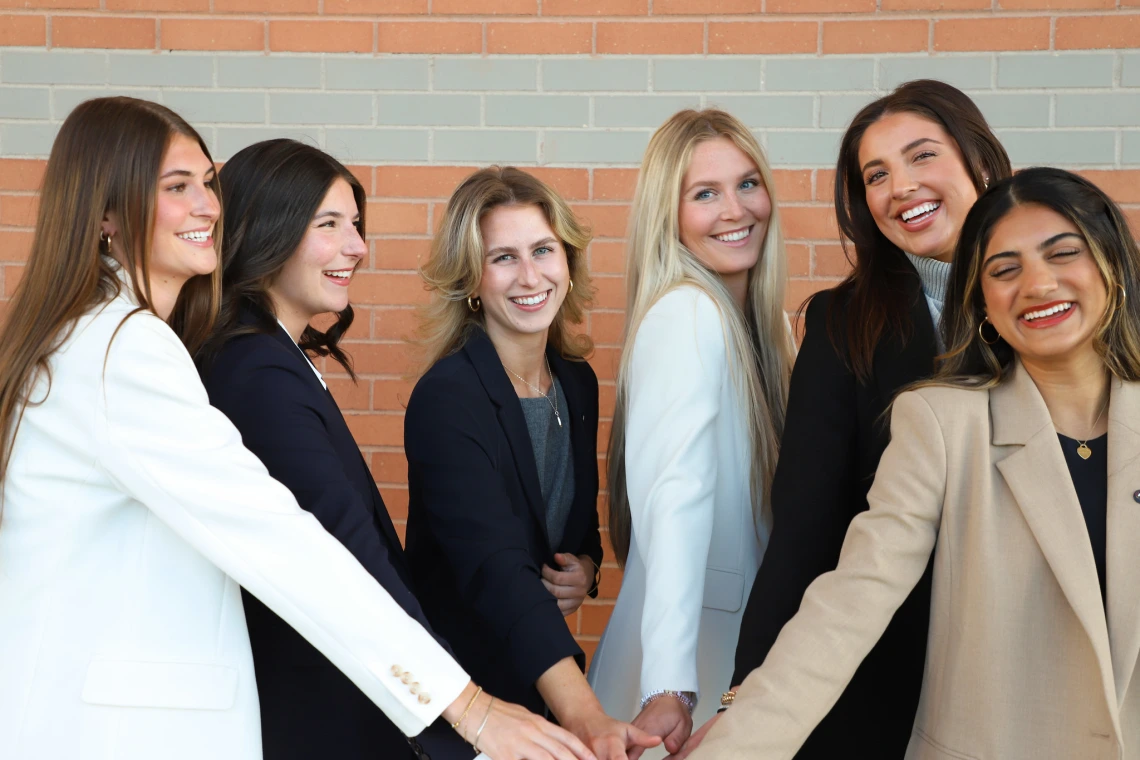 girls putting hands in a group