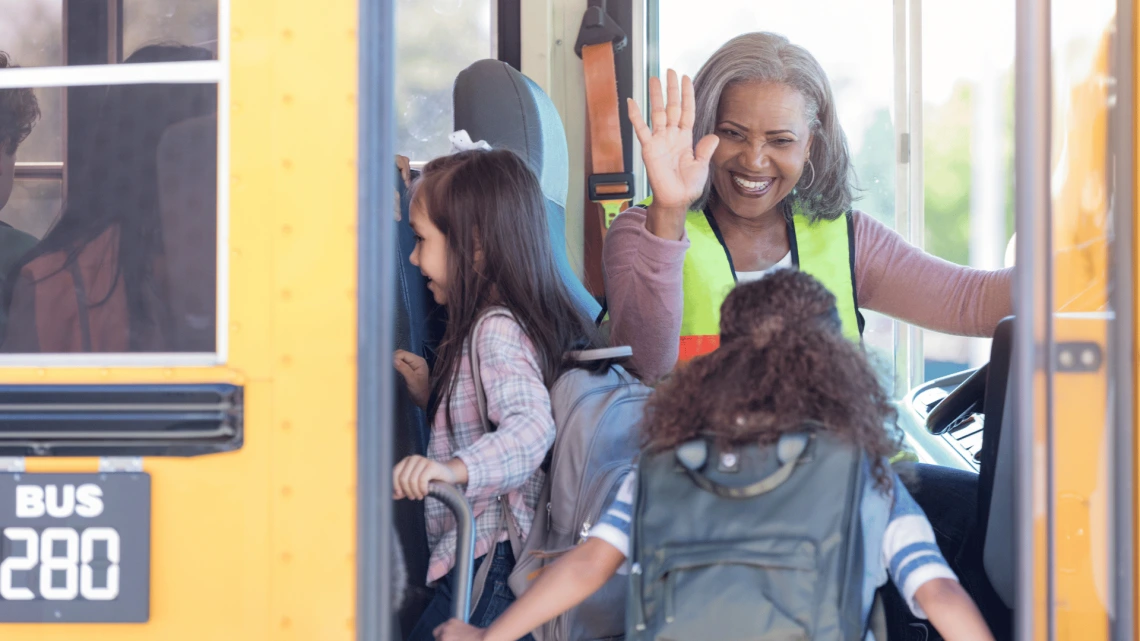 children going onto school bus