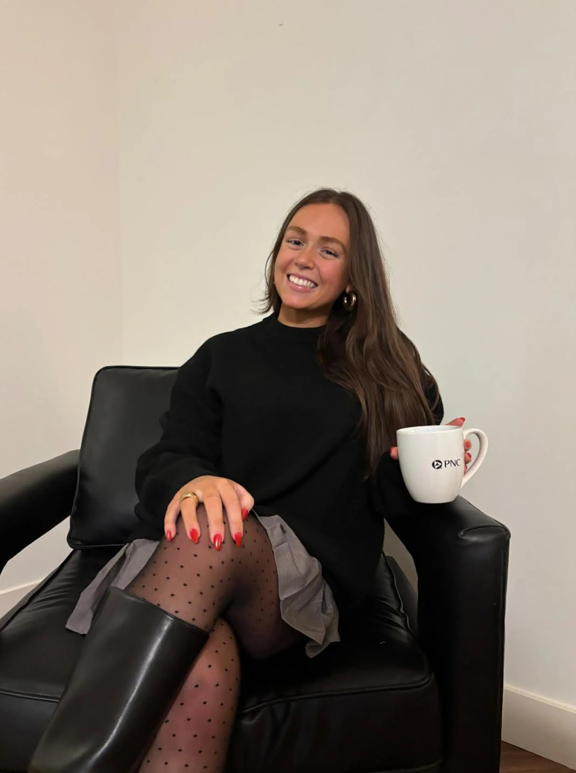 woman on a chair holding coffee