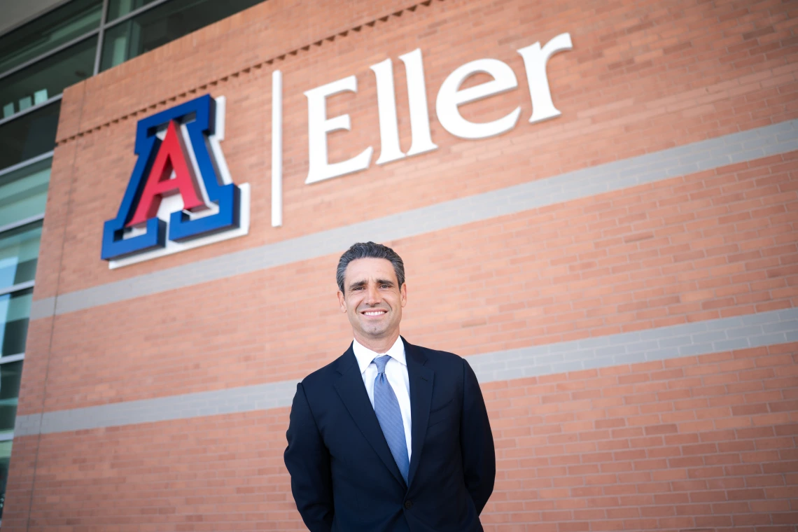 Ernie Garcia below the Eller logo sign outside of McClelland Hall