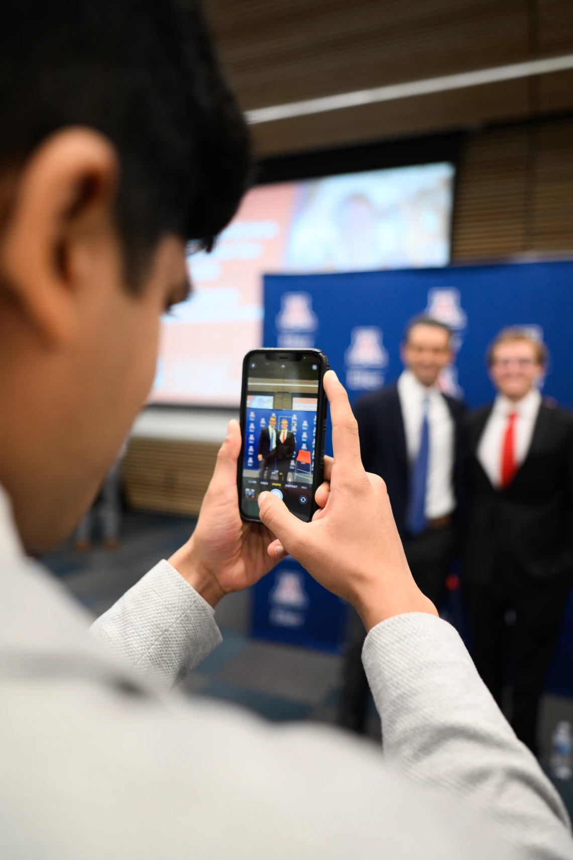 Students taking photos with Ernie