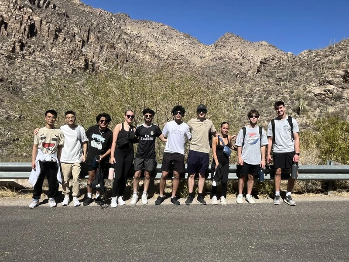 Students on a hike in front of the mountains