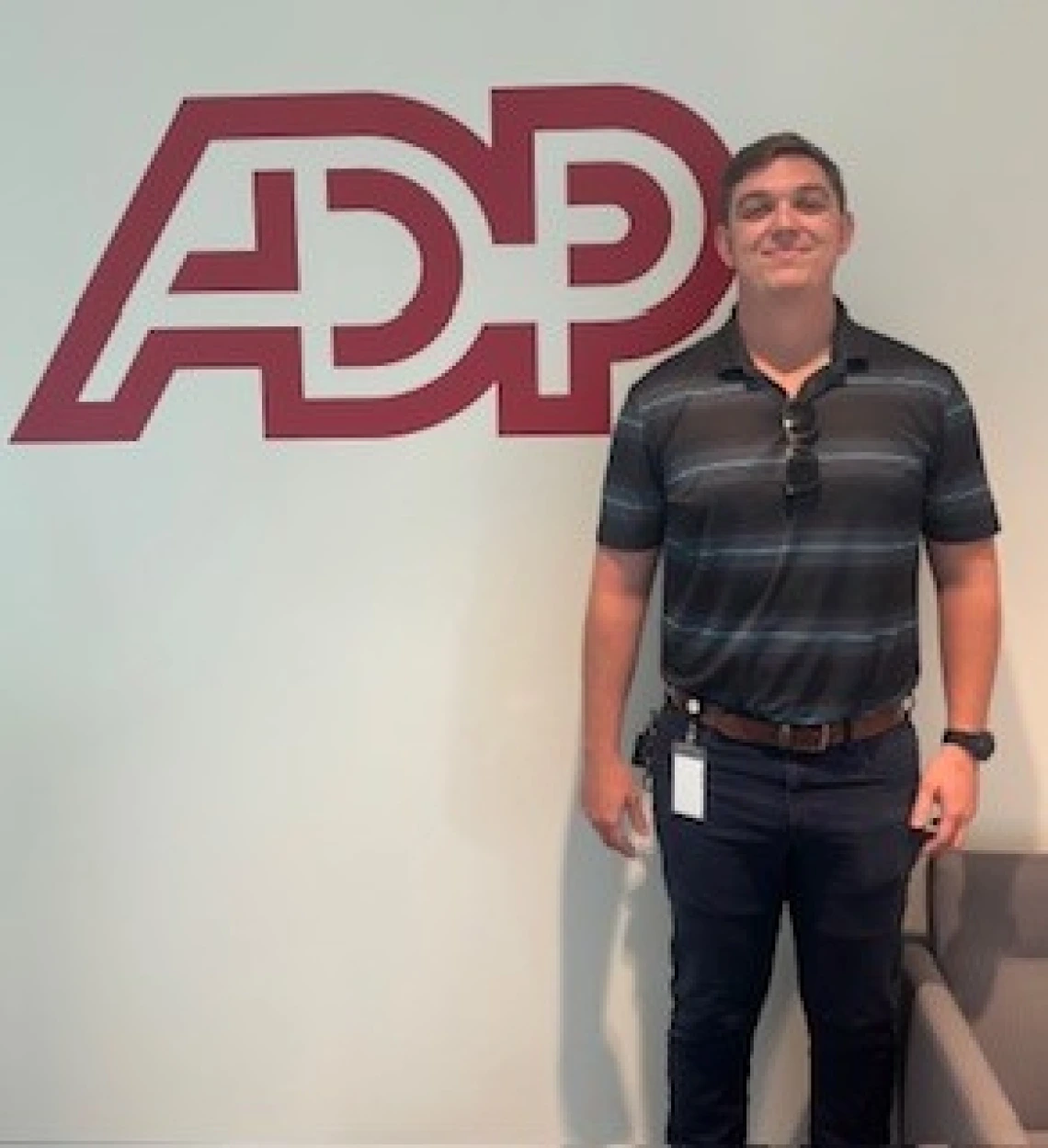 man standing in front of ADP logo