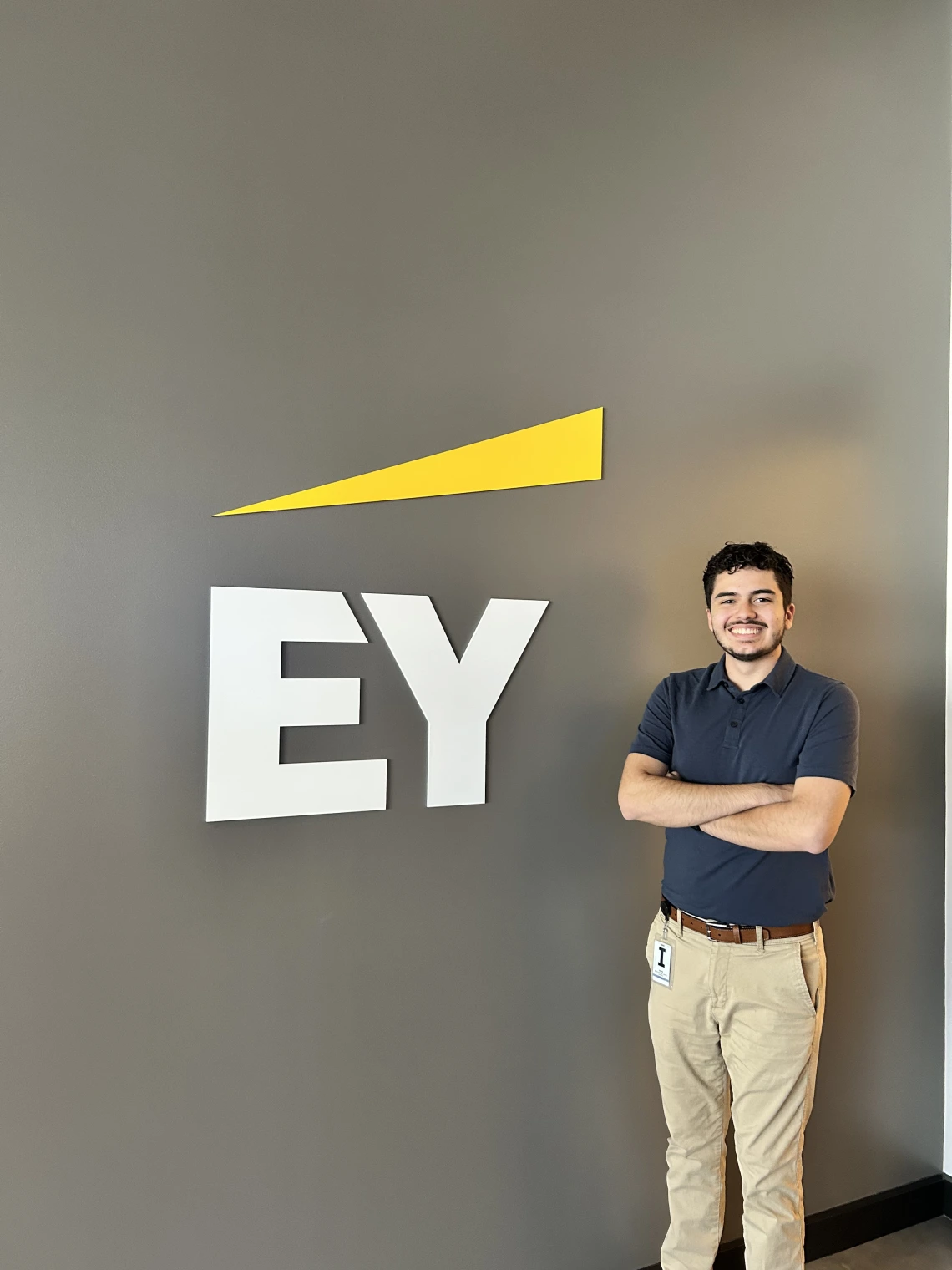 man standing in front of EY logo