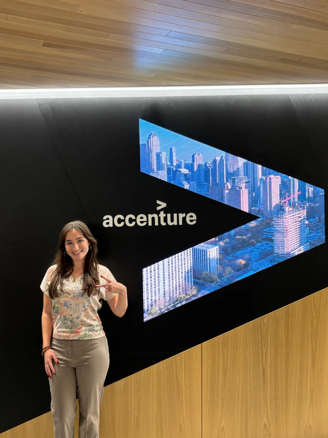 girl standing in front of accenture logo