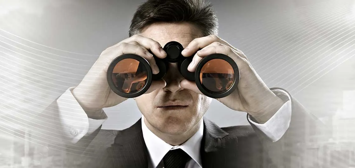 businessman with binoculars in cityscape