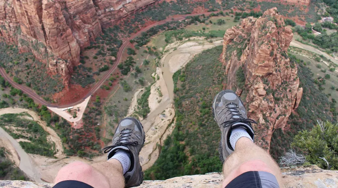 Man sitting above canyon