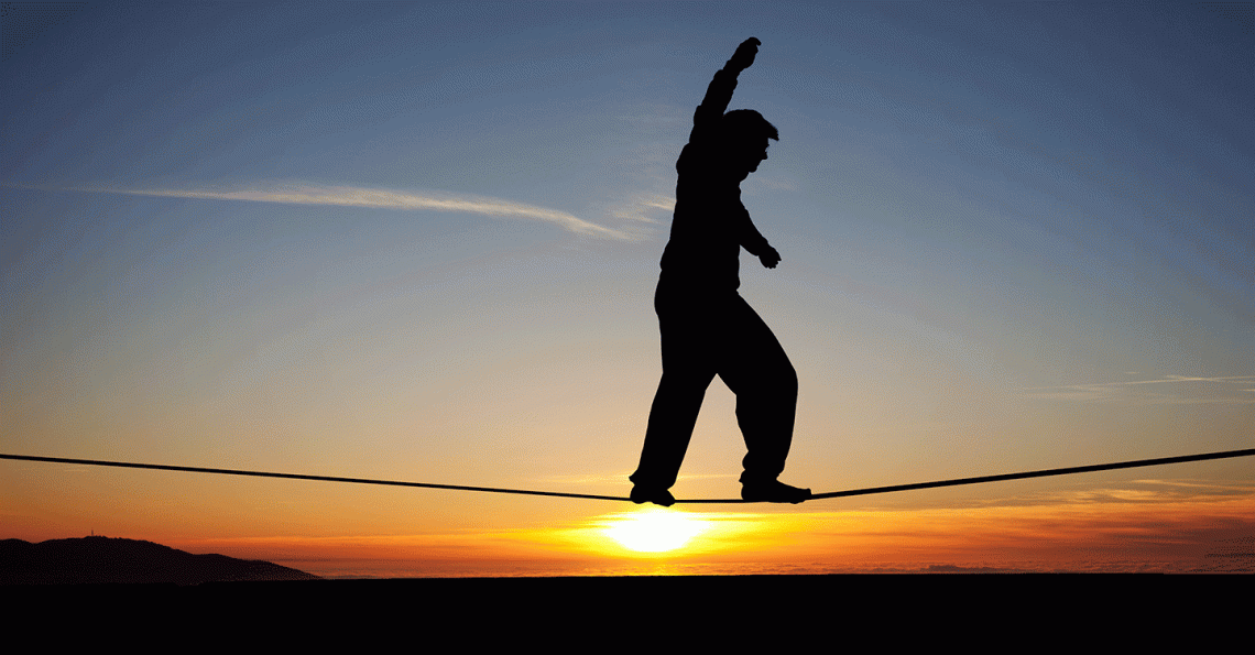 Person on high wire at sunrise