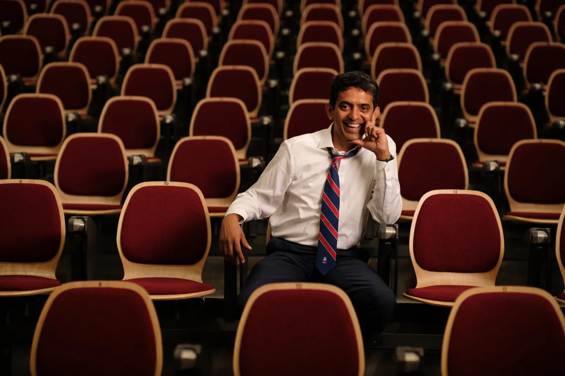 dean karthik kannan sitting in a chair