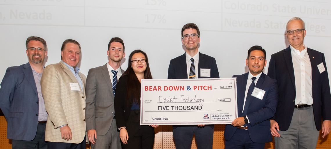 student team with $5000 check