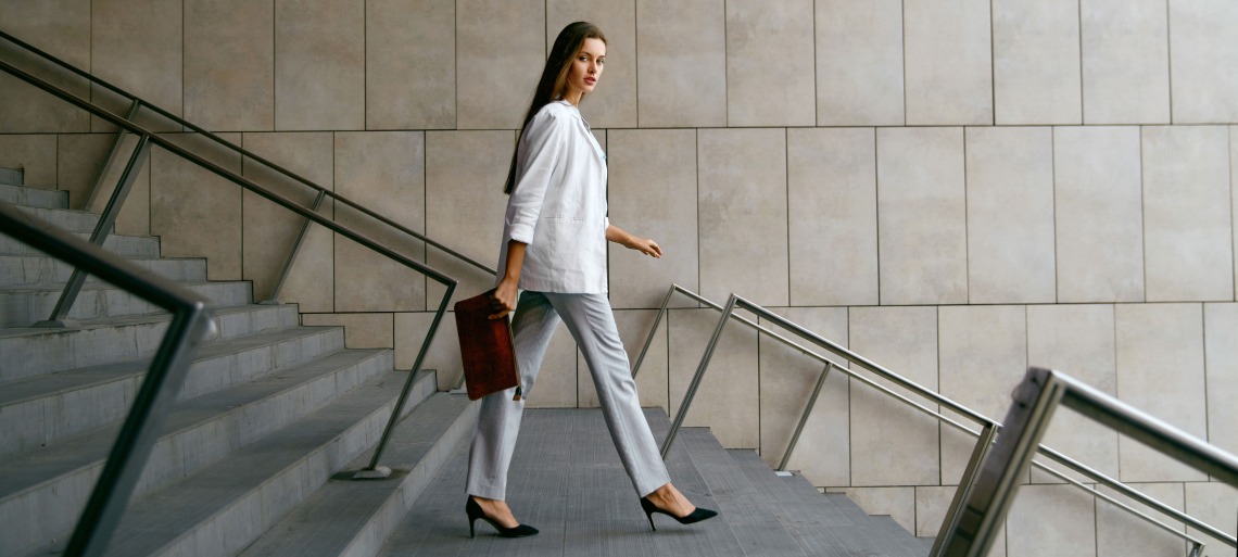 Business woman walking with a purse
