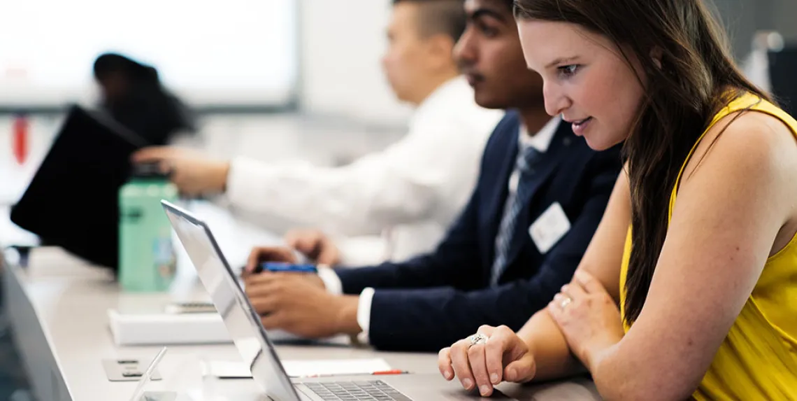 MBA students on laptop computers