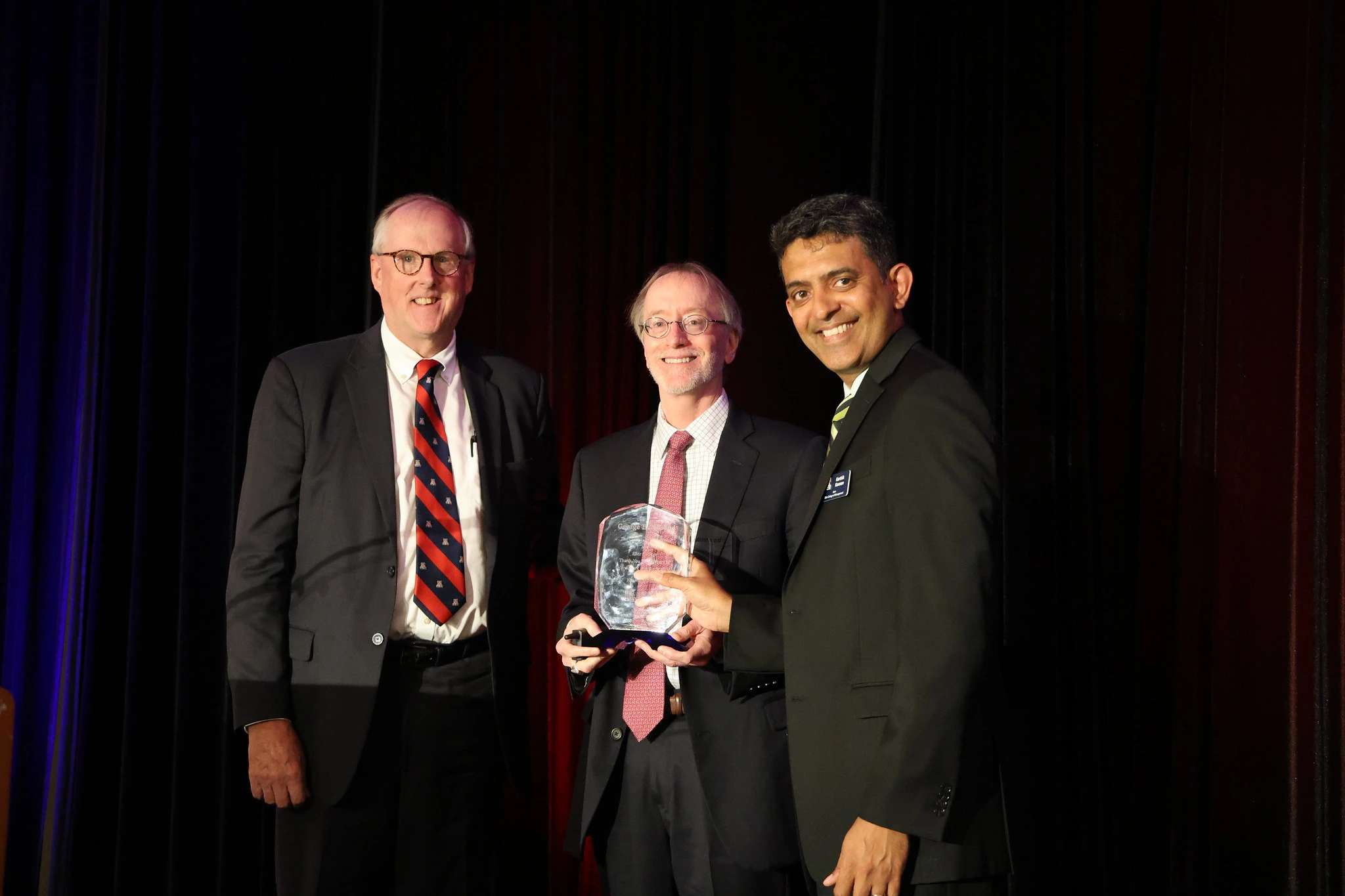 three men and an award
