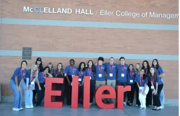 Group picture of student volunteers in front of building