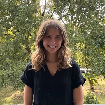 girl in front of trees