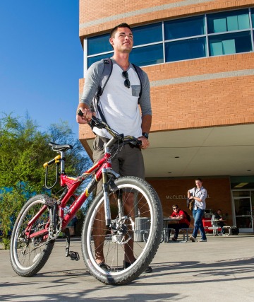 Eller Sports Management student with bicycle