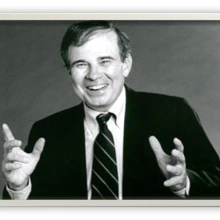 Dr. Jay Nunamaker wearing a suit and tie and smiling.