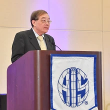 Dr. Ting-Peng Liang speaks while standing at a podium