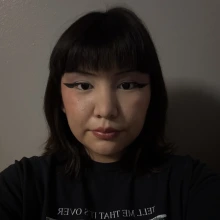 Student wearing a black shirt and looking at the camera