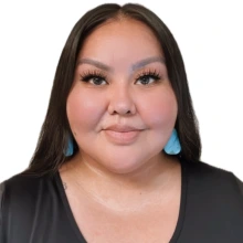 Student wearing a black shirt and light blue earrings