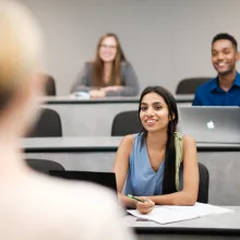 full time students in classroom looking at professor