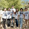 group of students posing for photo outside after volunteering. shirts say "live united"