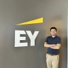 man standing in front of EY logo