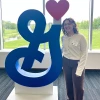 girl standing next to general mills logo