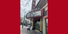 Man smiling in front of The Rialto Theater in Tucson.