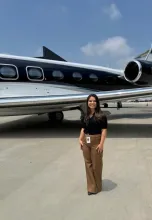 Girl standing in front of a plane