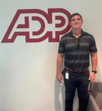 man standing in front of ADP logo