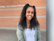 Brianna Fulp smiling at camera on steps of McClelland Hall