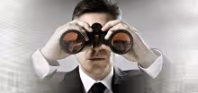 businessman with binoculars in cityscape